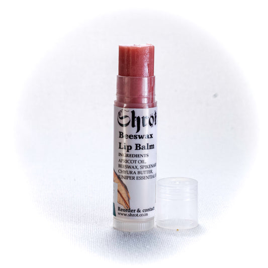 Tinted Lip balm with a white label on a white background. Side angle.