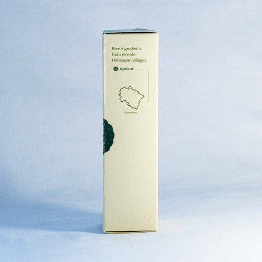 Rectangular box with green text and apricot illustration by a natural skincare brand called Shrot on a light blue background
