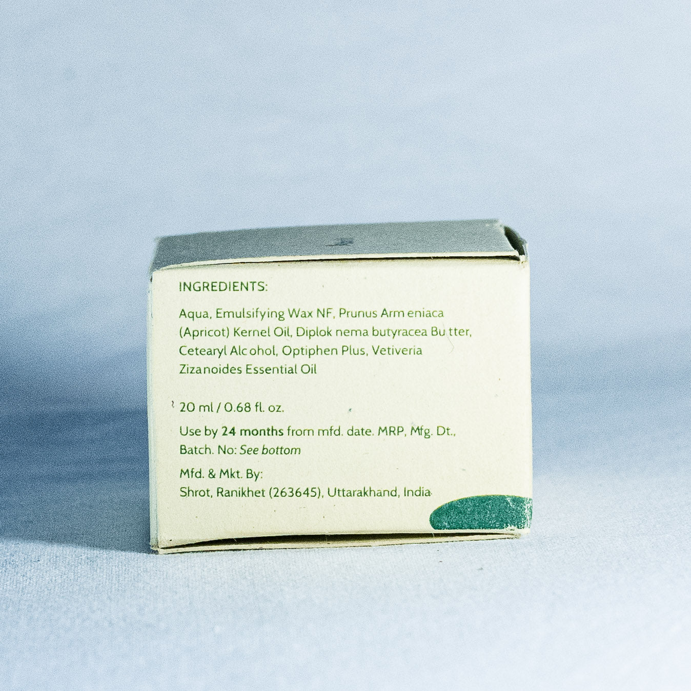 Back of a skincare product box with ingredient list on a light blue background by a trending Indian skincare brand called Shrot