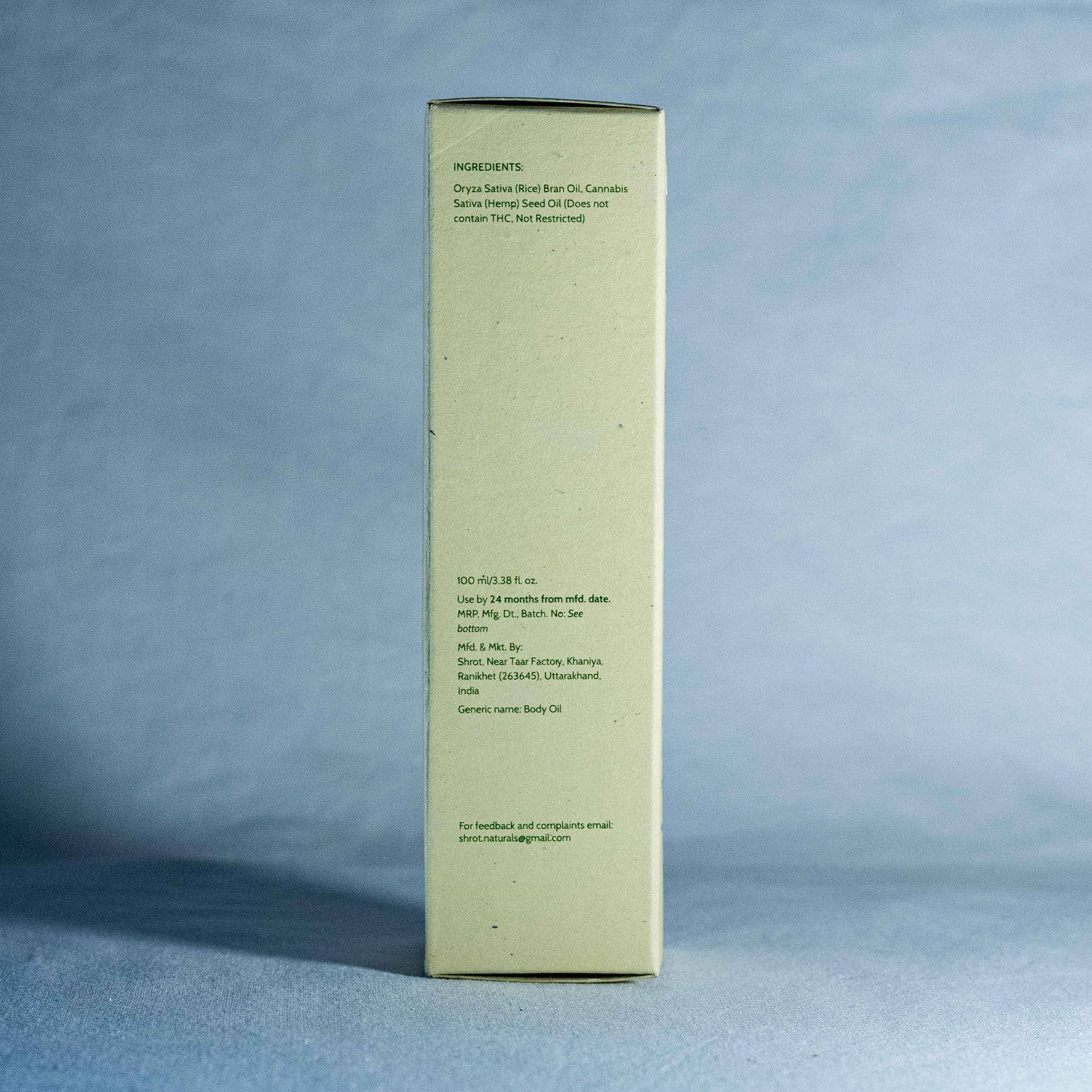 Tall rectangular box with text by a natural skincare brand called Shrot on a gray background