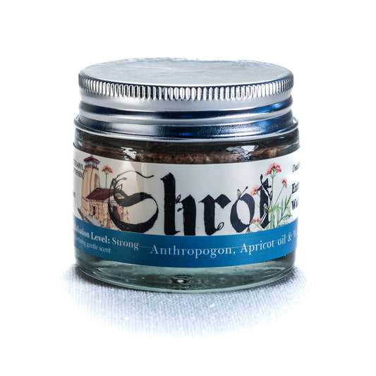 Jar of Shrot walnut foot scrub with label on a white background. Front angle.