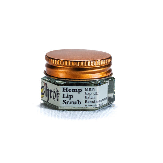 Jar of hemp lip scrub by Shrot with a gold lid on a white background, side view