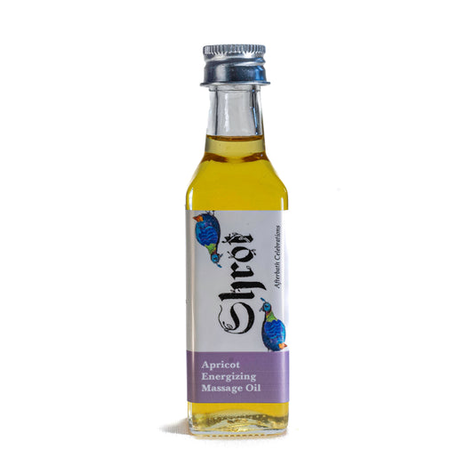 Bottle of Shrot apricot energizing massage oil on a white background. Front angle.