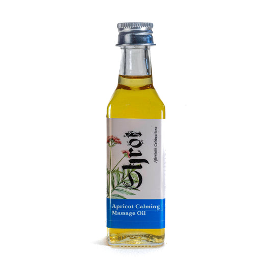 Bottle of Shrot apricot calming massage oil with a label on a white background