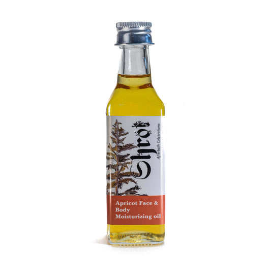 Bottle of apricot face and body moisturizing oil by Shrot with a label on a white background. Front angle.