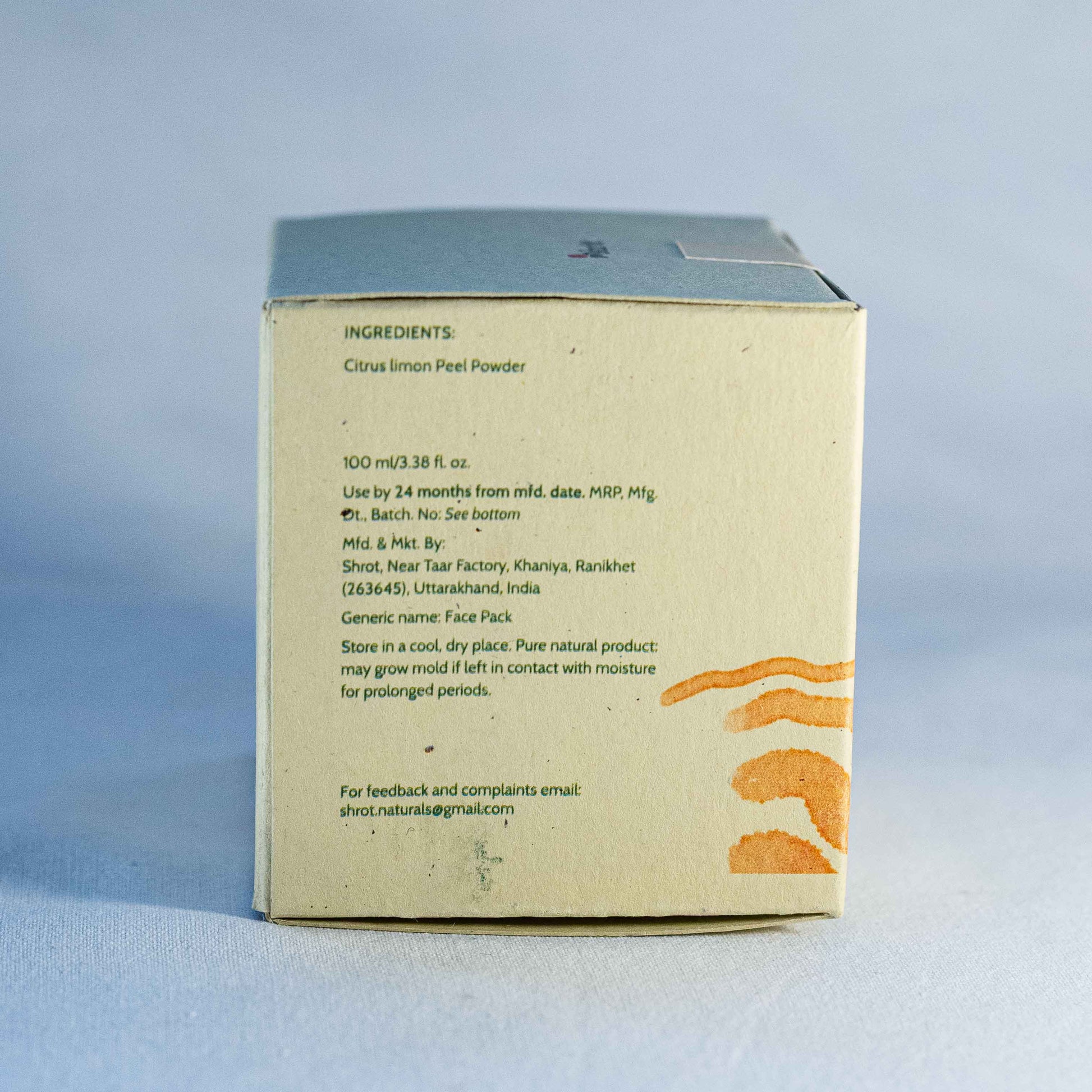 Back of a product box by Shrot natural cosmetics with text on a light blue background