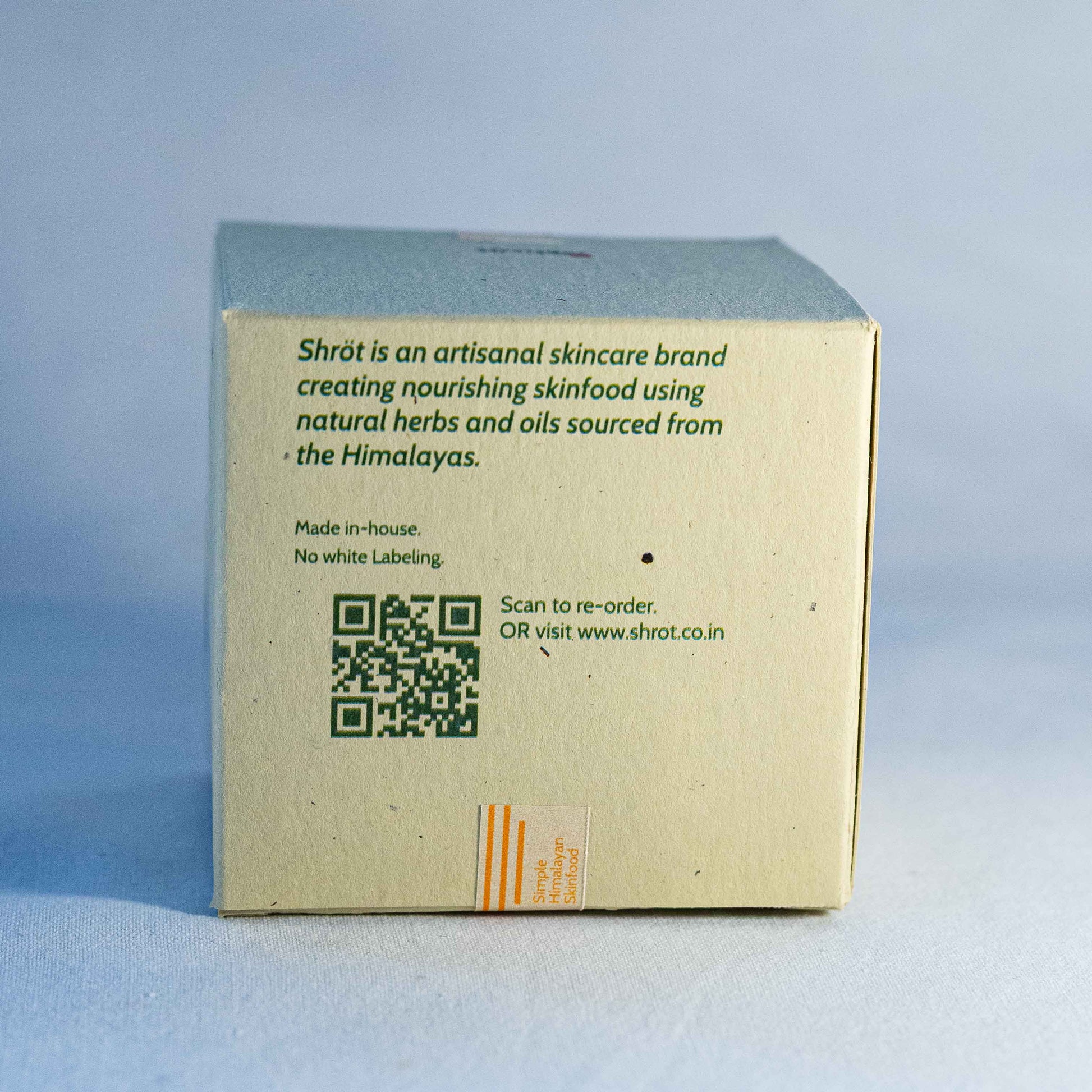 Back of a Shrot skincare product box with branding and QR code on a light blue background