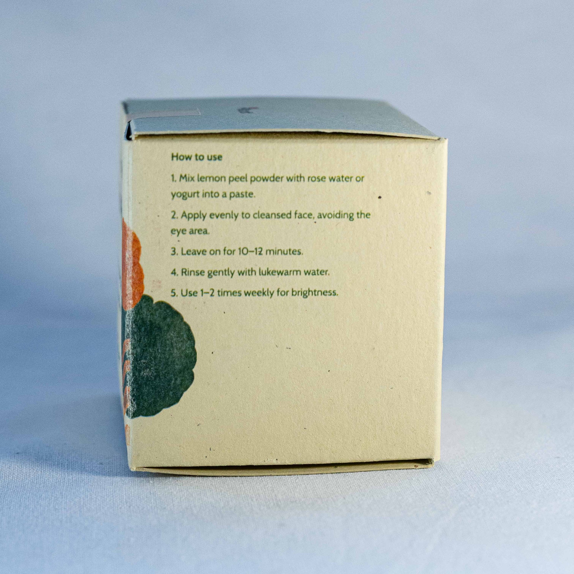 Back of a skincare product box by Shrot natural cosmetics with usage instructions on a light blue background