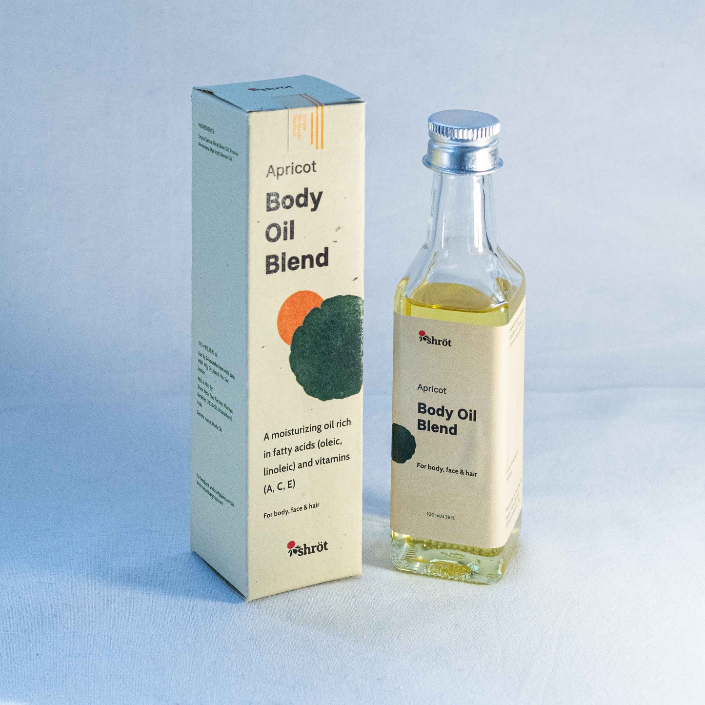 Apricot body oil blend packaging with bottle by a natural skincare brand called Shrot on a light blue background