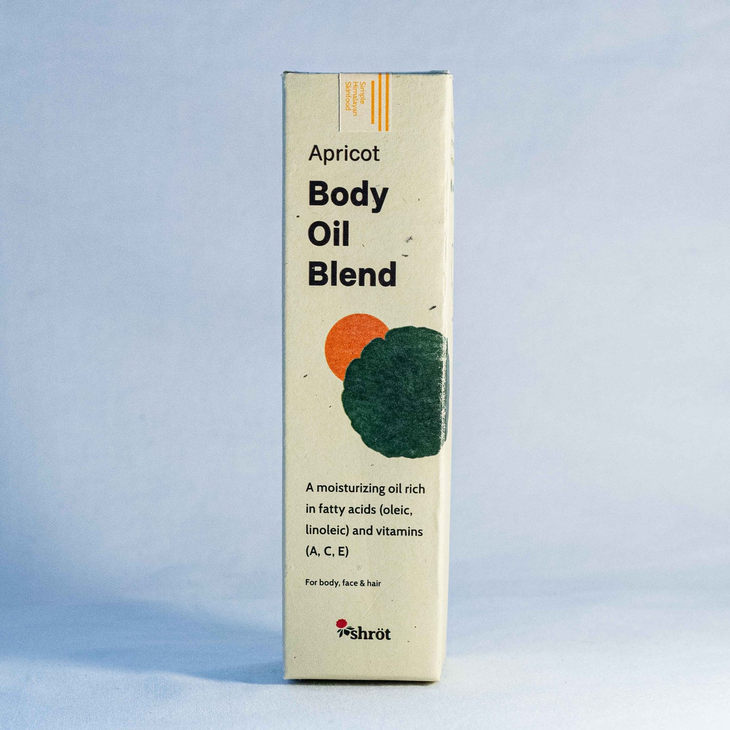 Box of Apricot Body Oil Blend by a natural skincare brand called Shrot on a light blue background