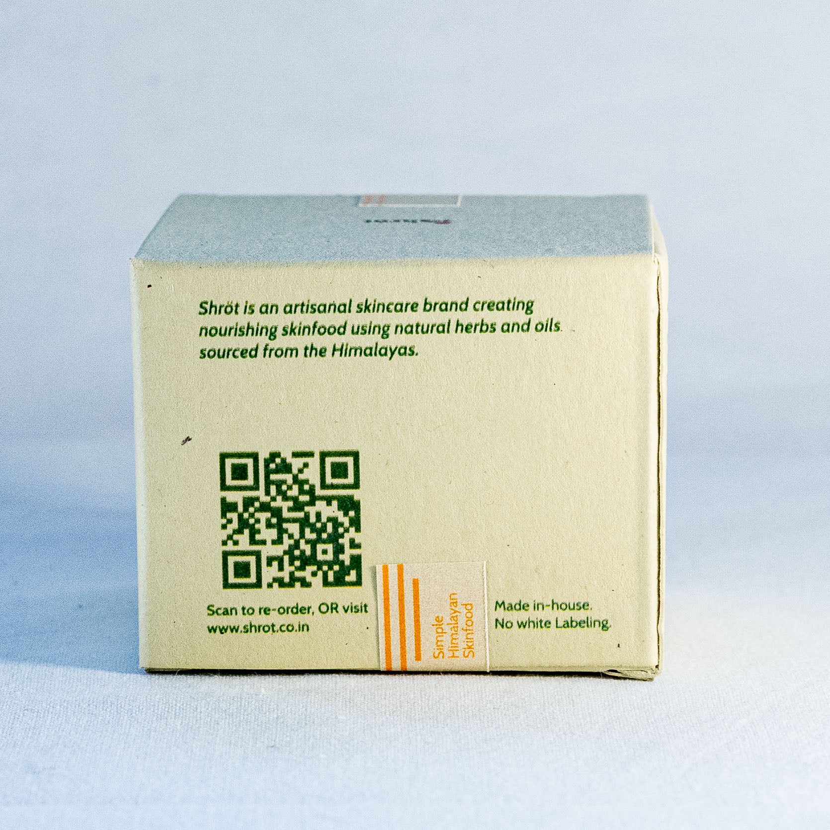 Skincare product box with QR code and branding text on a light blue background by a natural skincare brand called Shrot