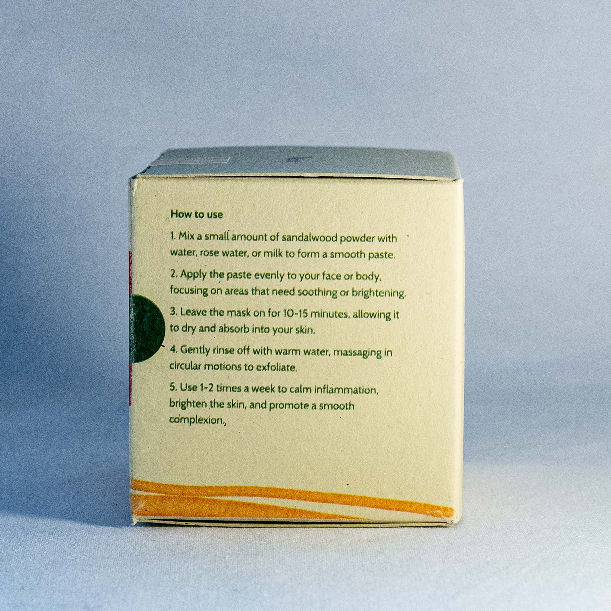 Instructions on a sandalwood powder packaging Shrot Natural beauty products against a gray background