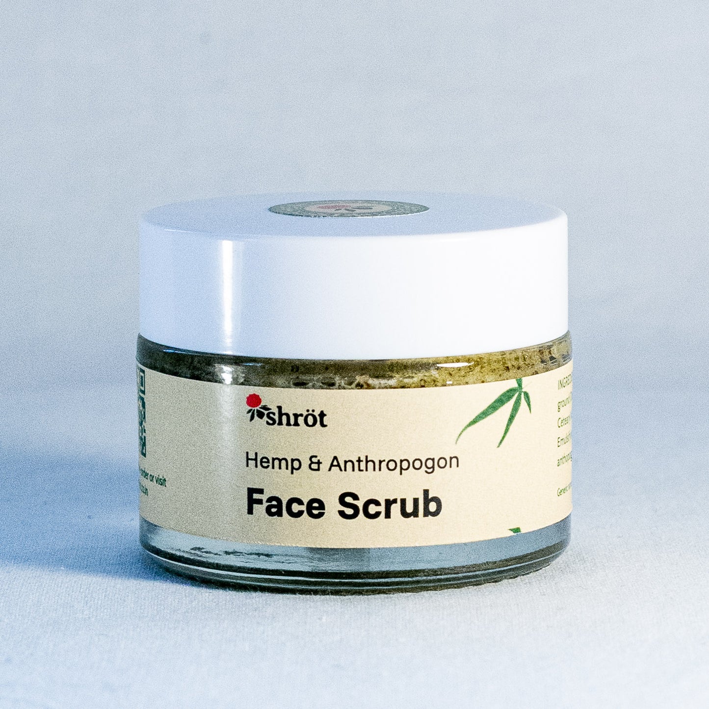 Jar of face scrub with a white lid on a light gray background by a natural skincare brand called Shrot 