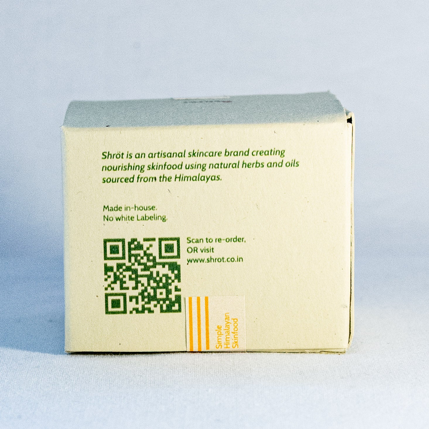 Skincare product box with QR code and branding text on a light gray background by a natural skincare brand called Shrot 