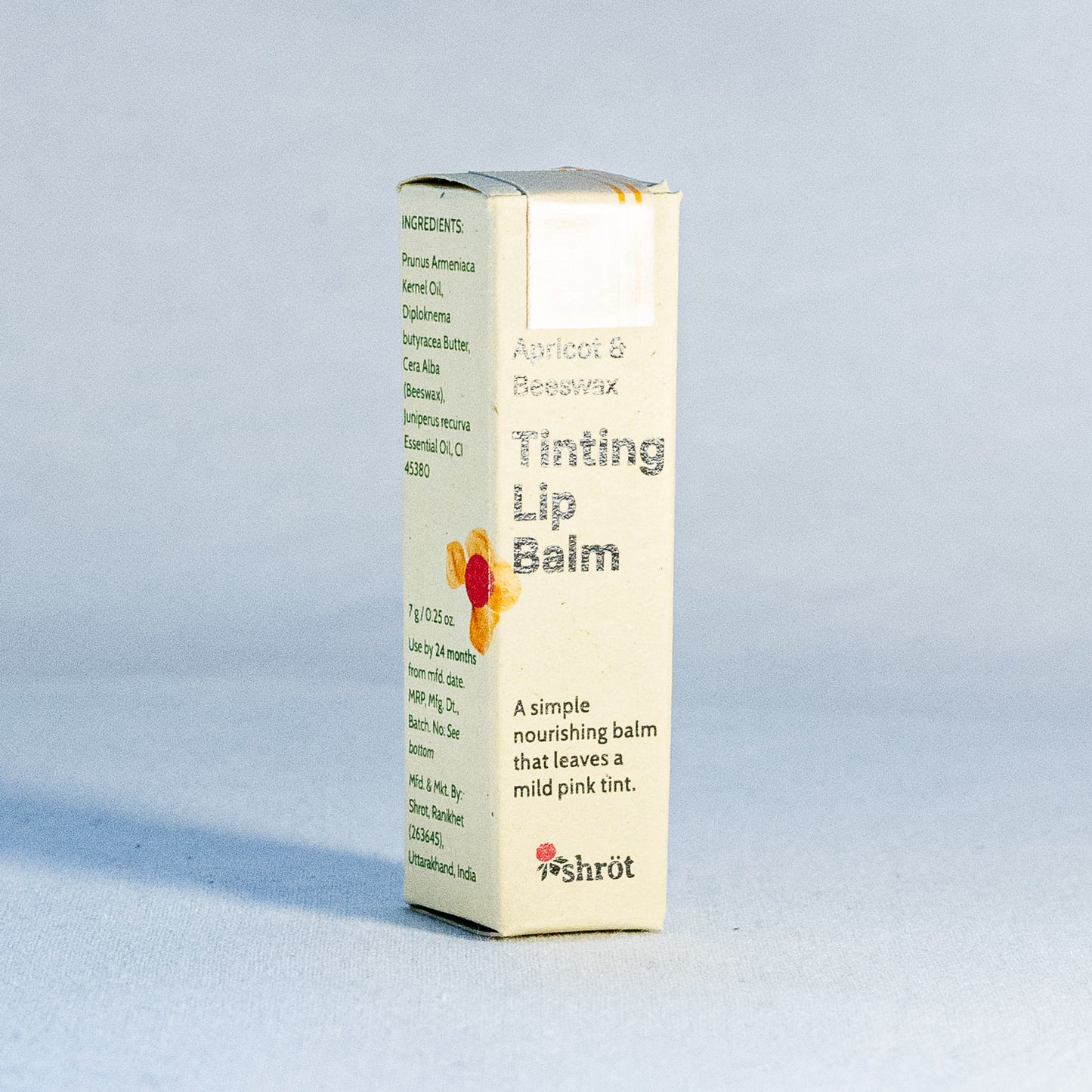 Box of Shrot Tinting Lip Balm on a light gray background by a natural skincare brand called Shrot 