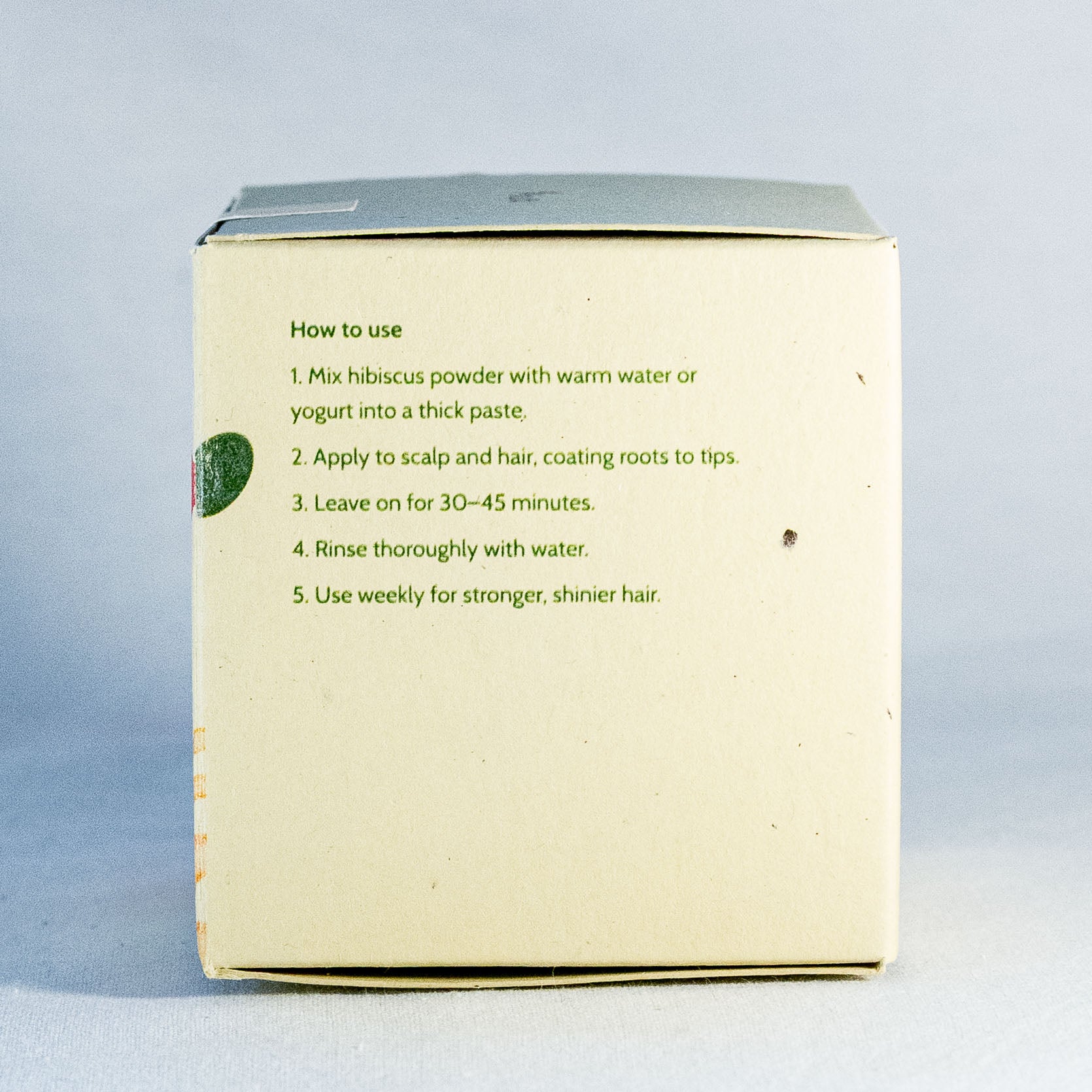 Box with hibiscus powder usage instructions by Shrot natural skincare  on a light gray background