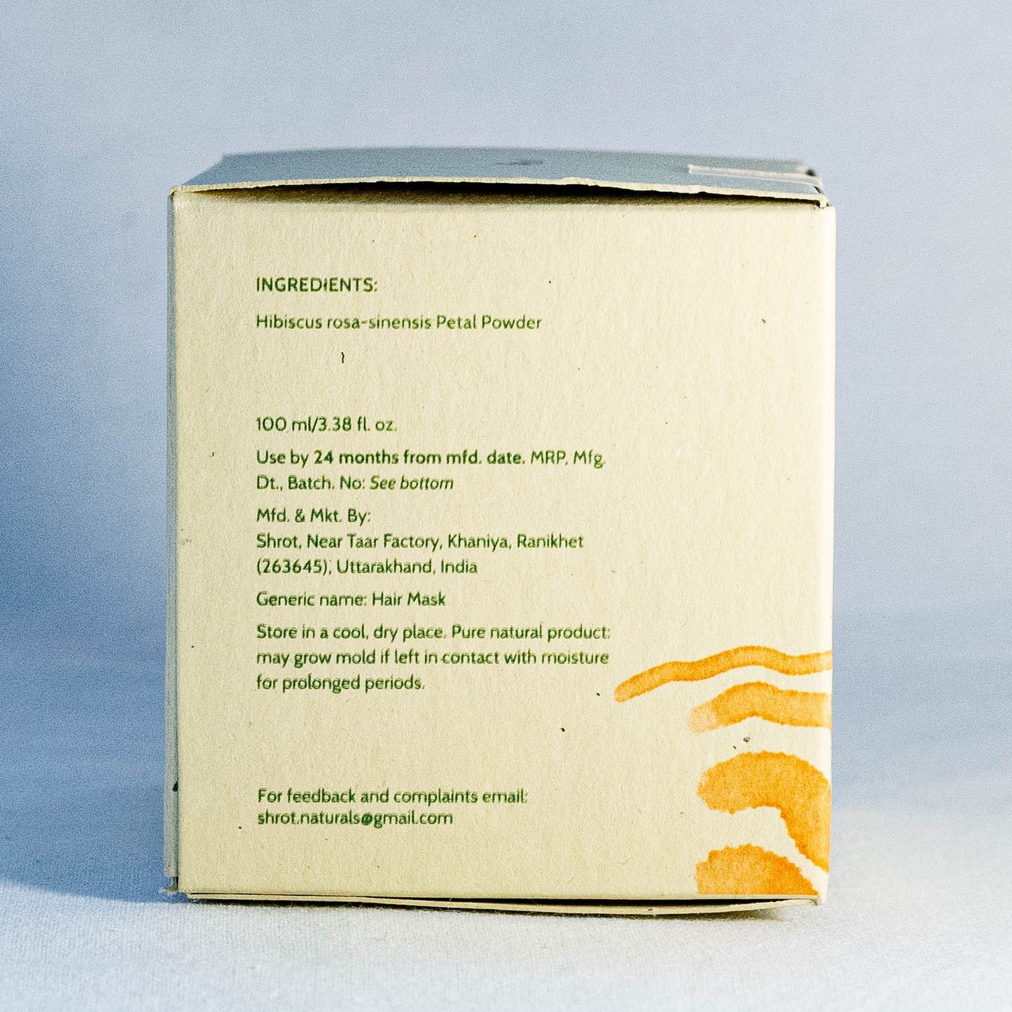 Back of a hair mask packaging box by Shrot natural skincare with ingredient list and instructions on a light blue background