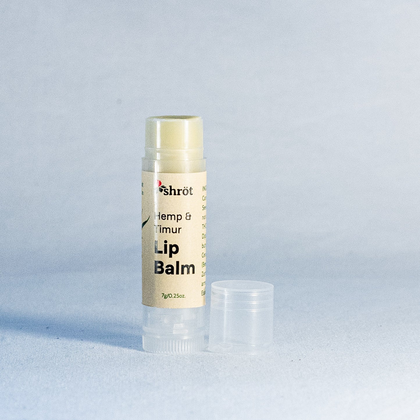 Lip balm by a natural skincare brand called Shrot on a light gray background