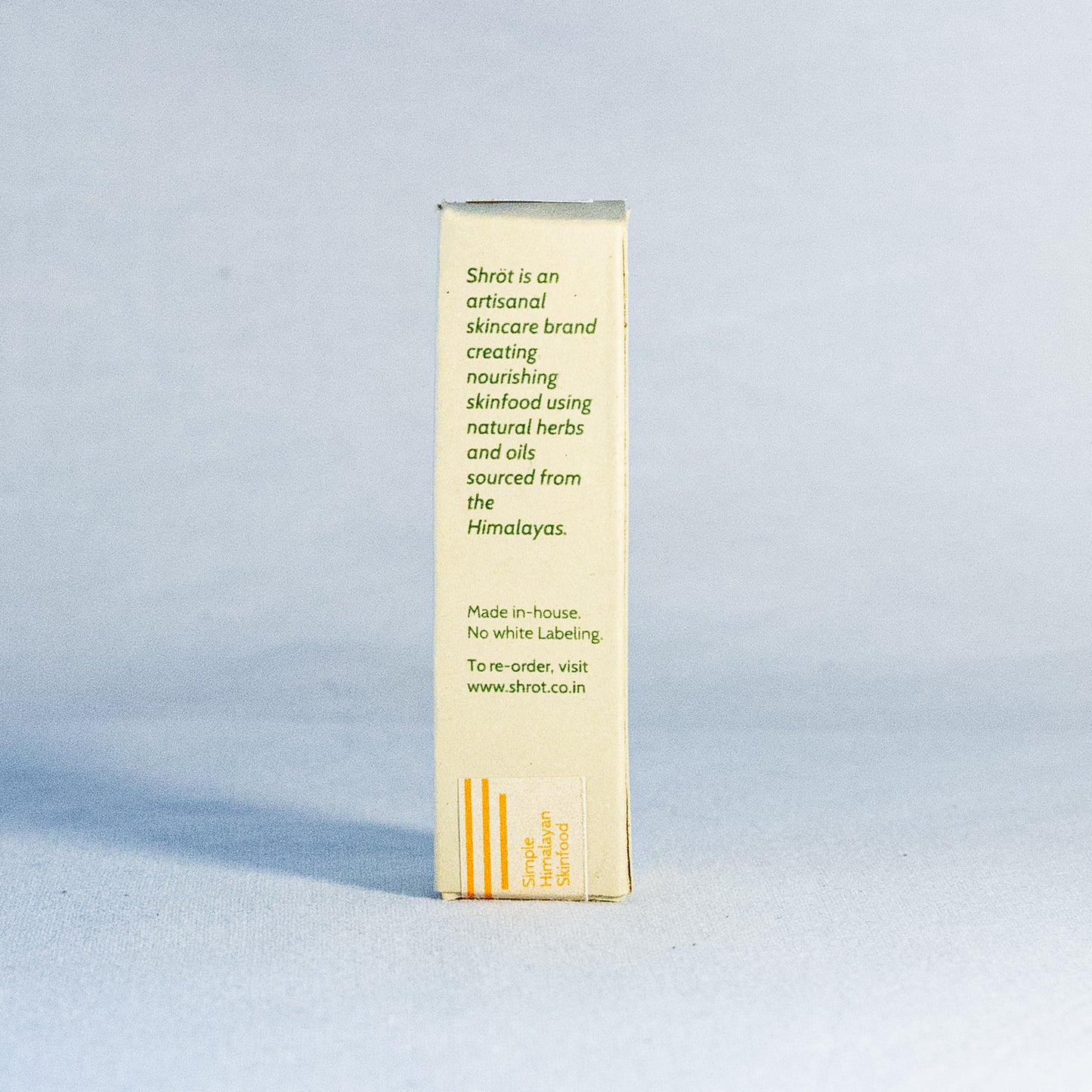 Skincare product box with text by a natural skincare brand called Shrot on a light blue background