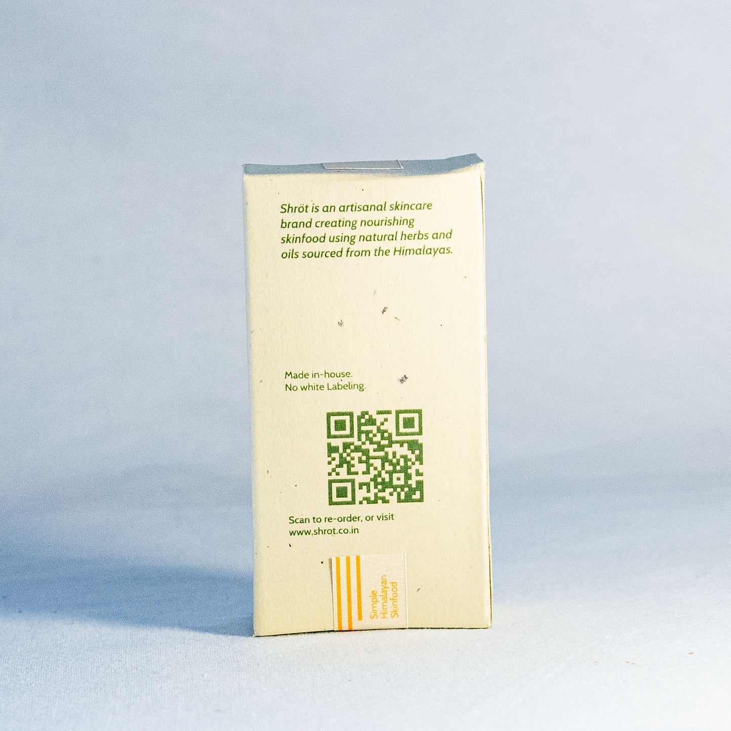 Natural skincare product packaging by Shrot with QR code and text on a light blue background