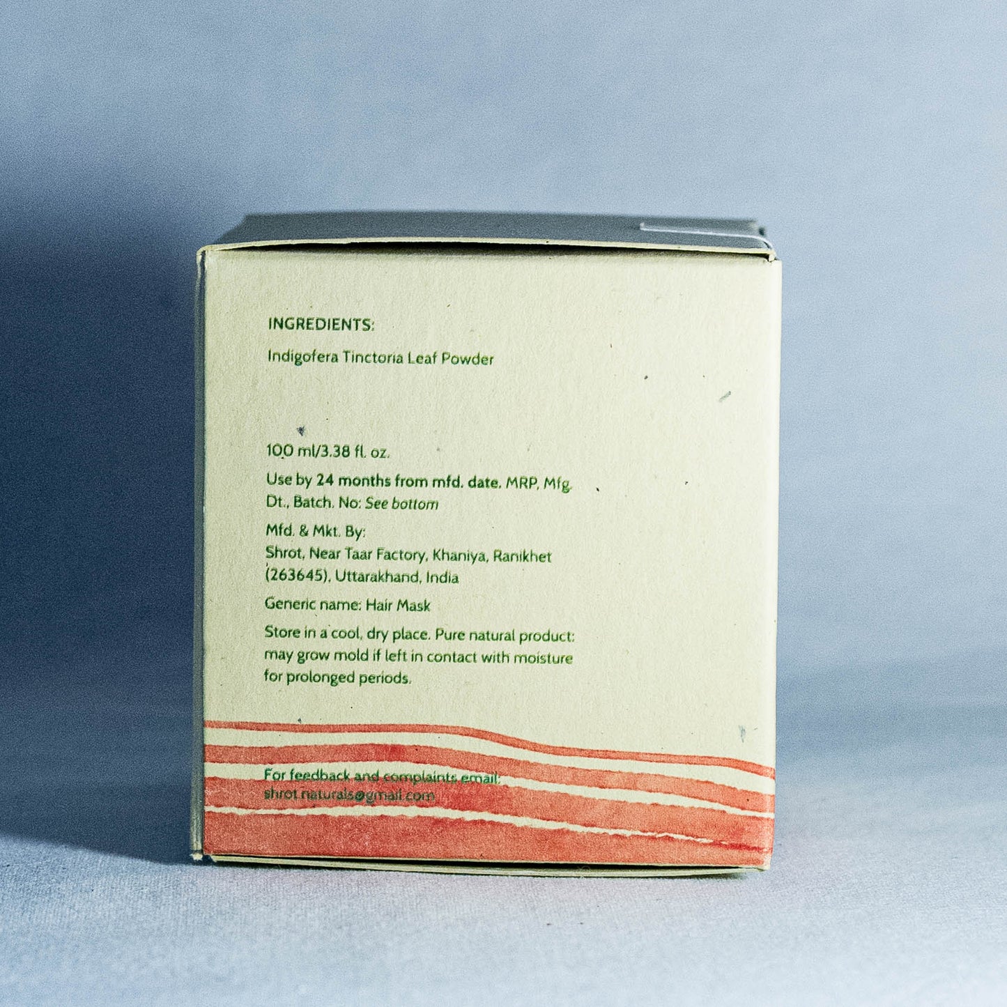 Back of a product packaging by Shrot Natural beauty products with text and red design on a gray background