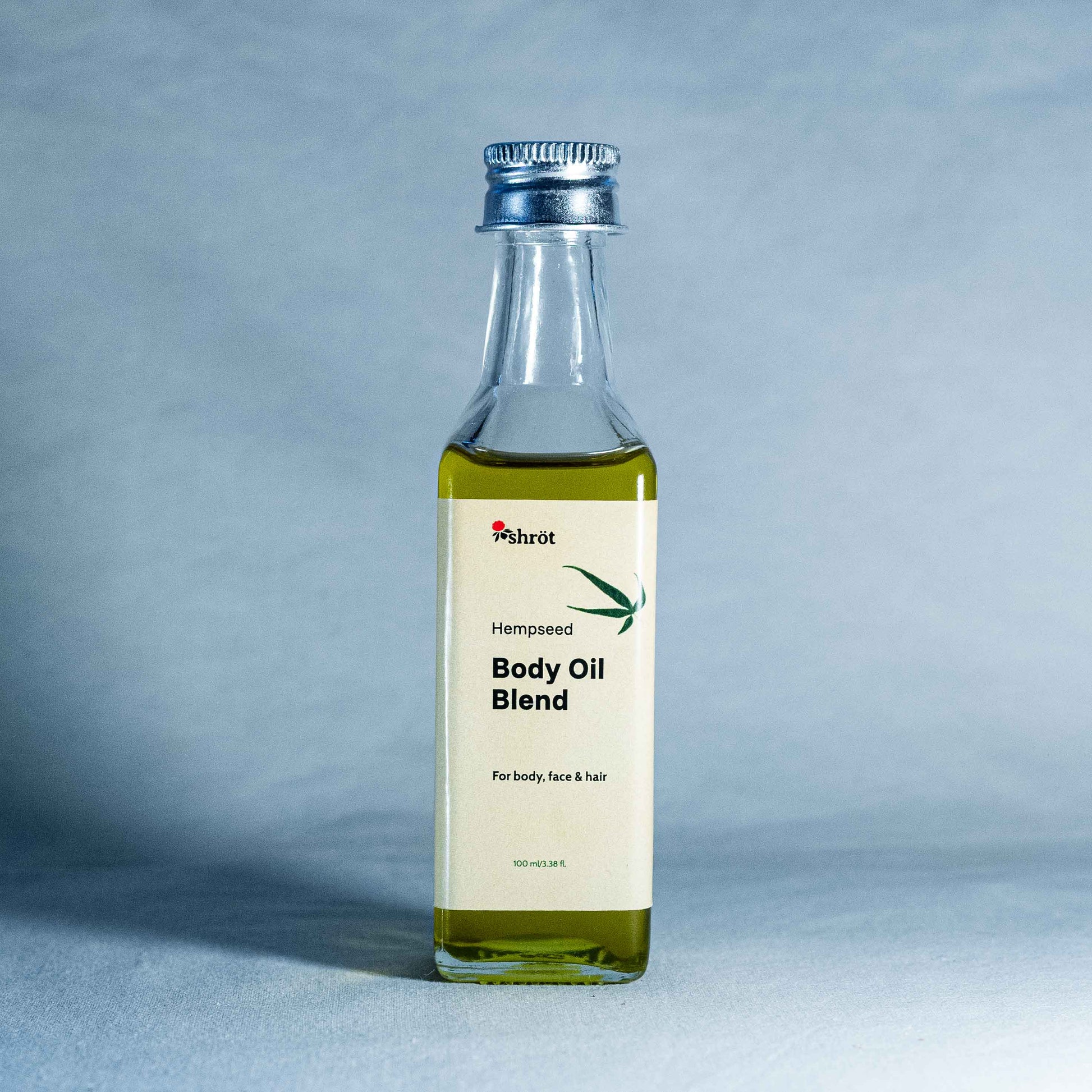 Bottle of Hempseed Body Oil Blend by a natural skincare brand called Shrot on a gray background