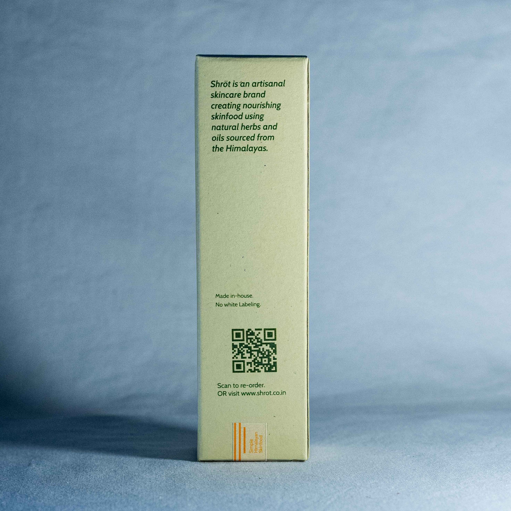 Skincare product box with brand information by a natural skincare brand called Shrot on a gray background