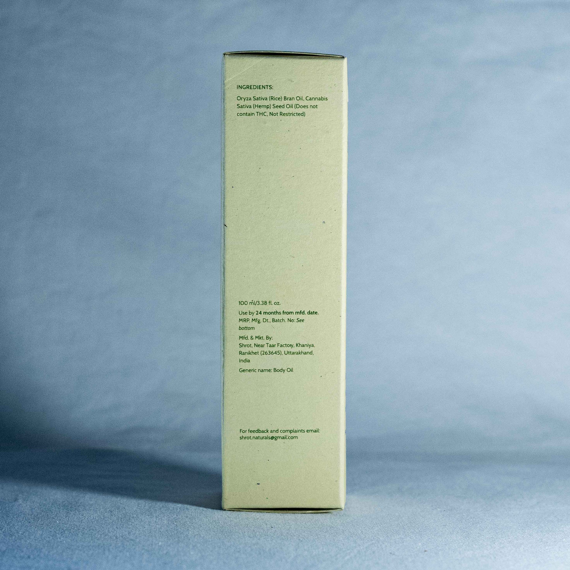 Tall rectangular box with text by a natural skincare brand called Shrot on a gray background