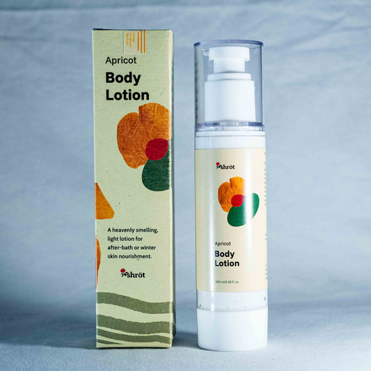 Apricot body lotion with packaging on a gray background by a trending Indian skincare brand called Shrot