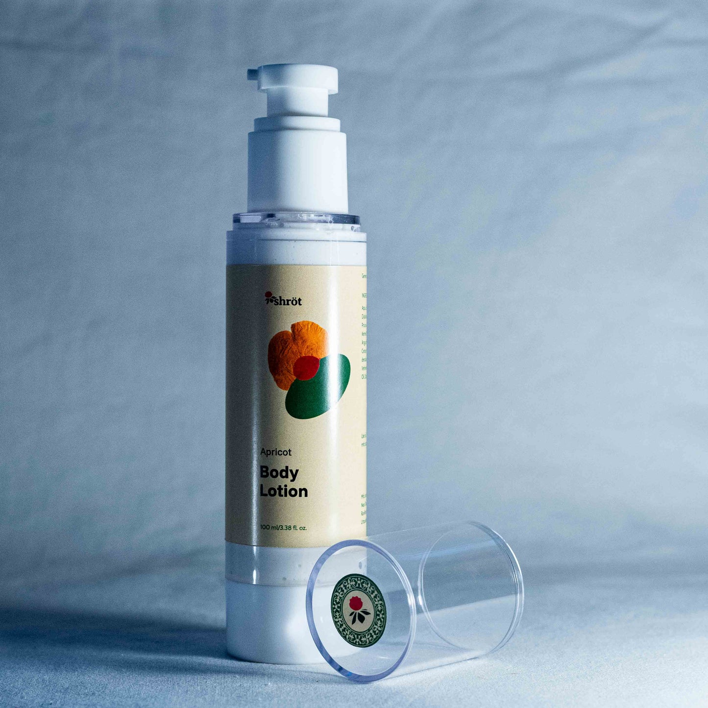 Body lotion bottle with pump on a gray background by a trending Indian skincare brand called Shrot