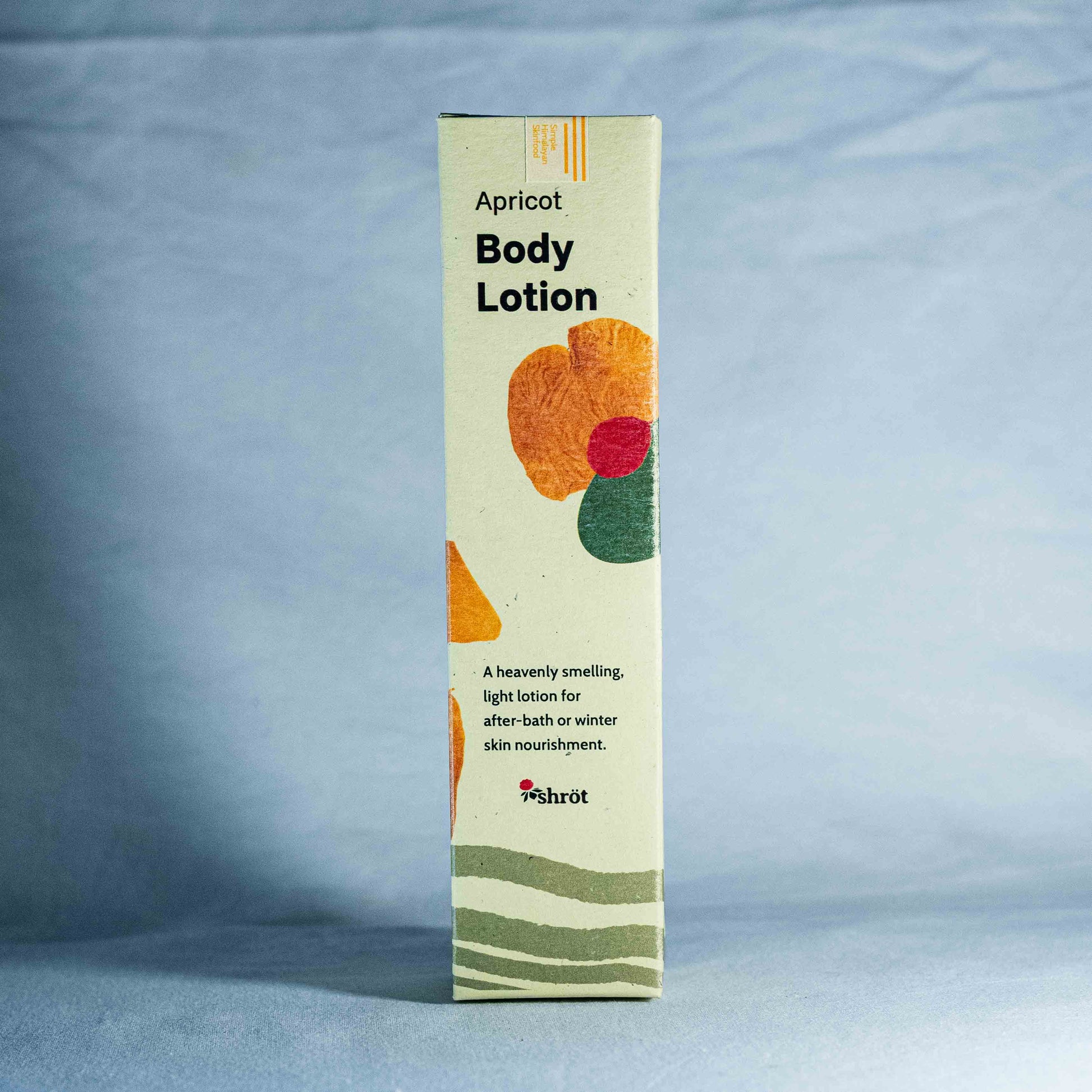 Apricot body lotion packaging on a blue background by a trending Indian skincare brand called Shrot