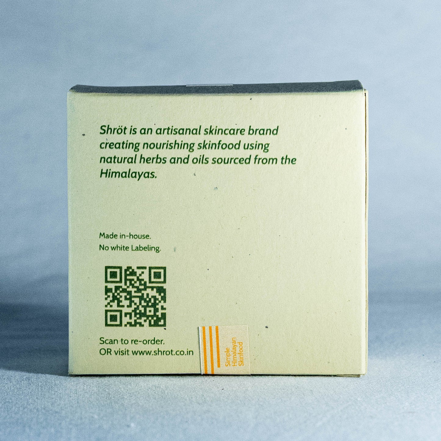 Back of a Shrot skincare product box with branding and QR code on a gray background