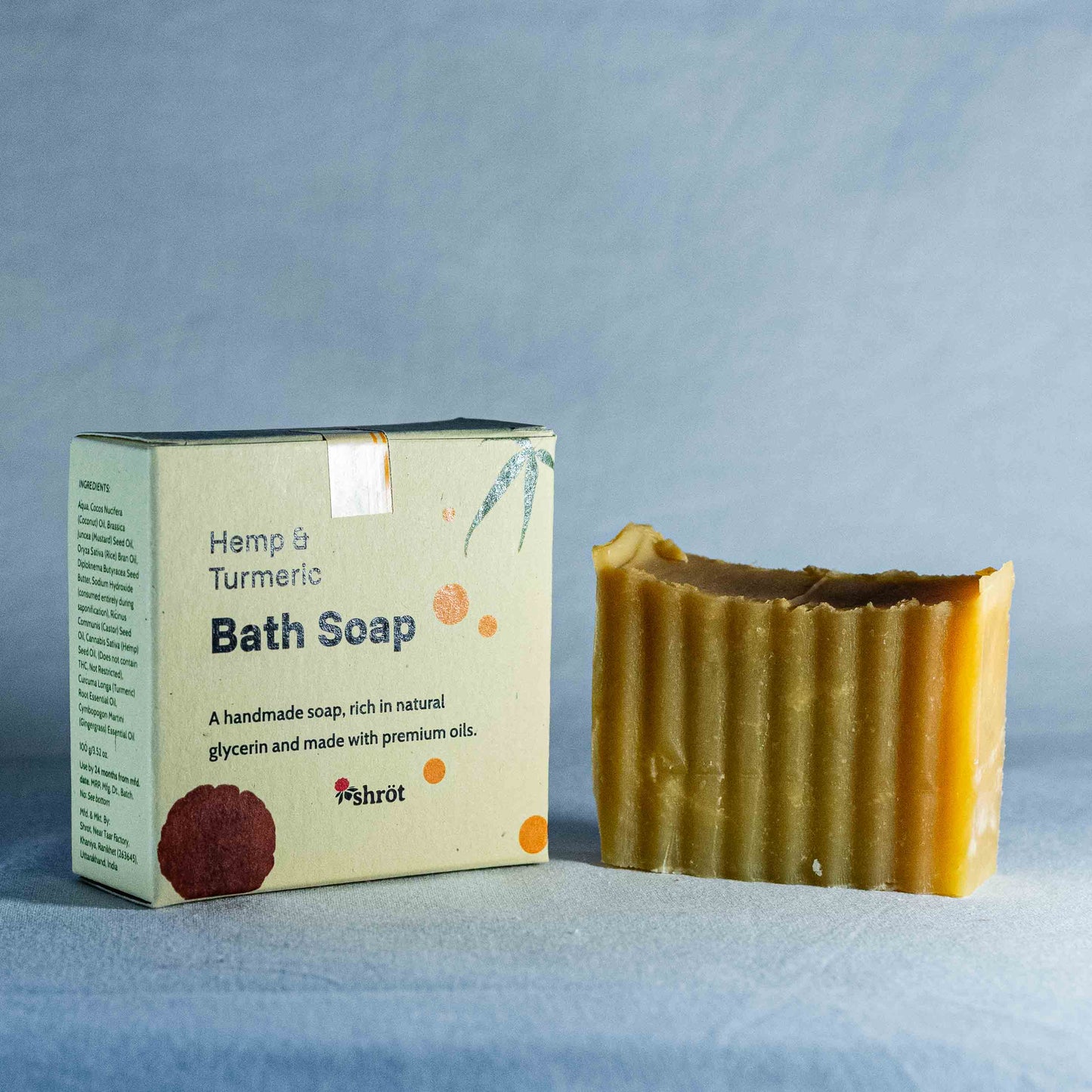 Hemp & Turmeric Bath Soap by Shrot with packaging on a blue background