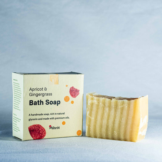 Bar of soap by Shrot and its packaging with 'Apricot & Gingergrass' text on a light gray background