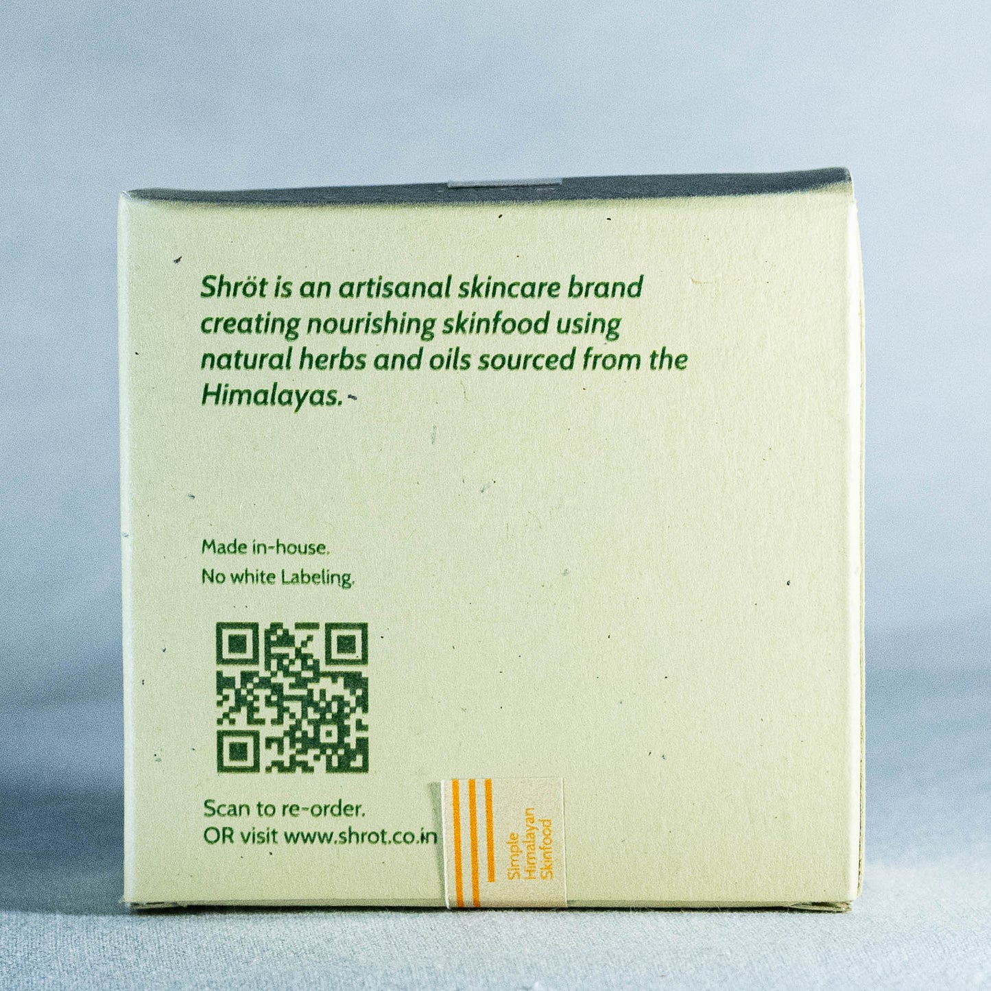 Back of a skincare product packaging by Shrot with text and QR code on a light gray background
