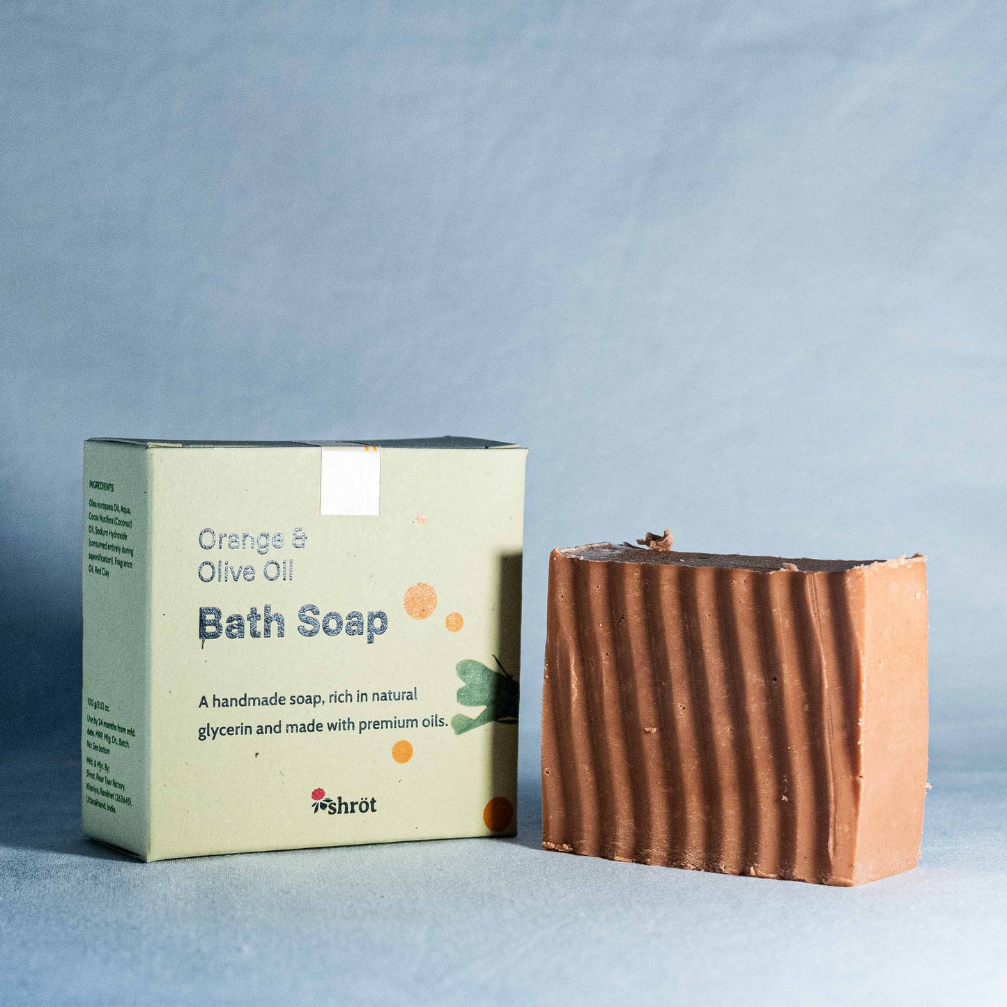 Bath soap bar and packaging on a light blue background